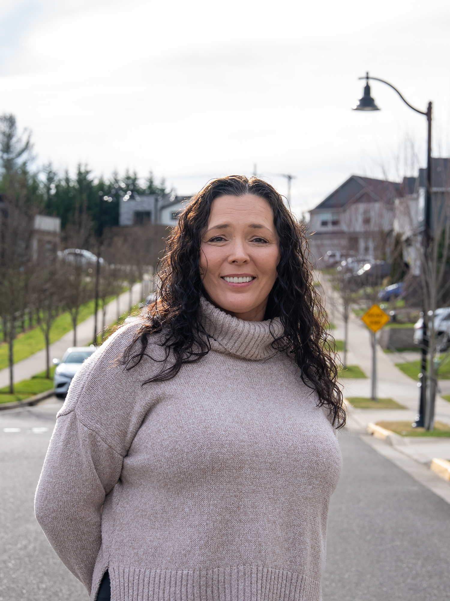 Dr. Tooke's patient Sherry smiling with confidence outside
